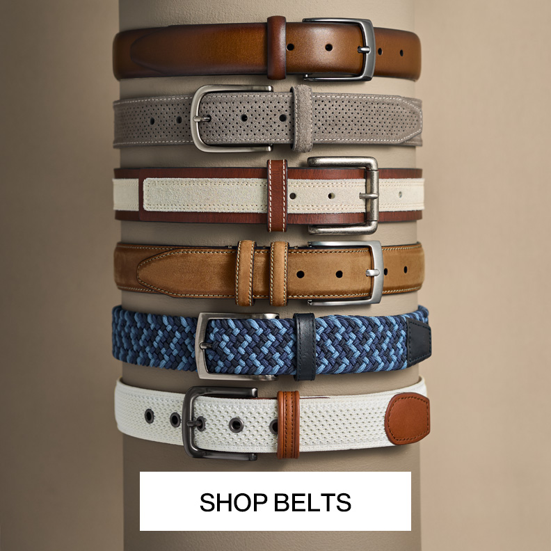 Flatlay of six men's belts lined up in a row.