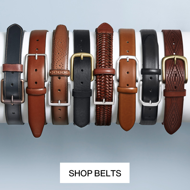 Flatlay of eight men's belts lined up in a row.
